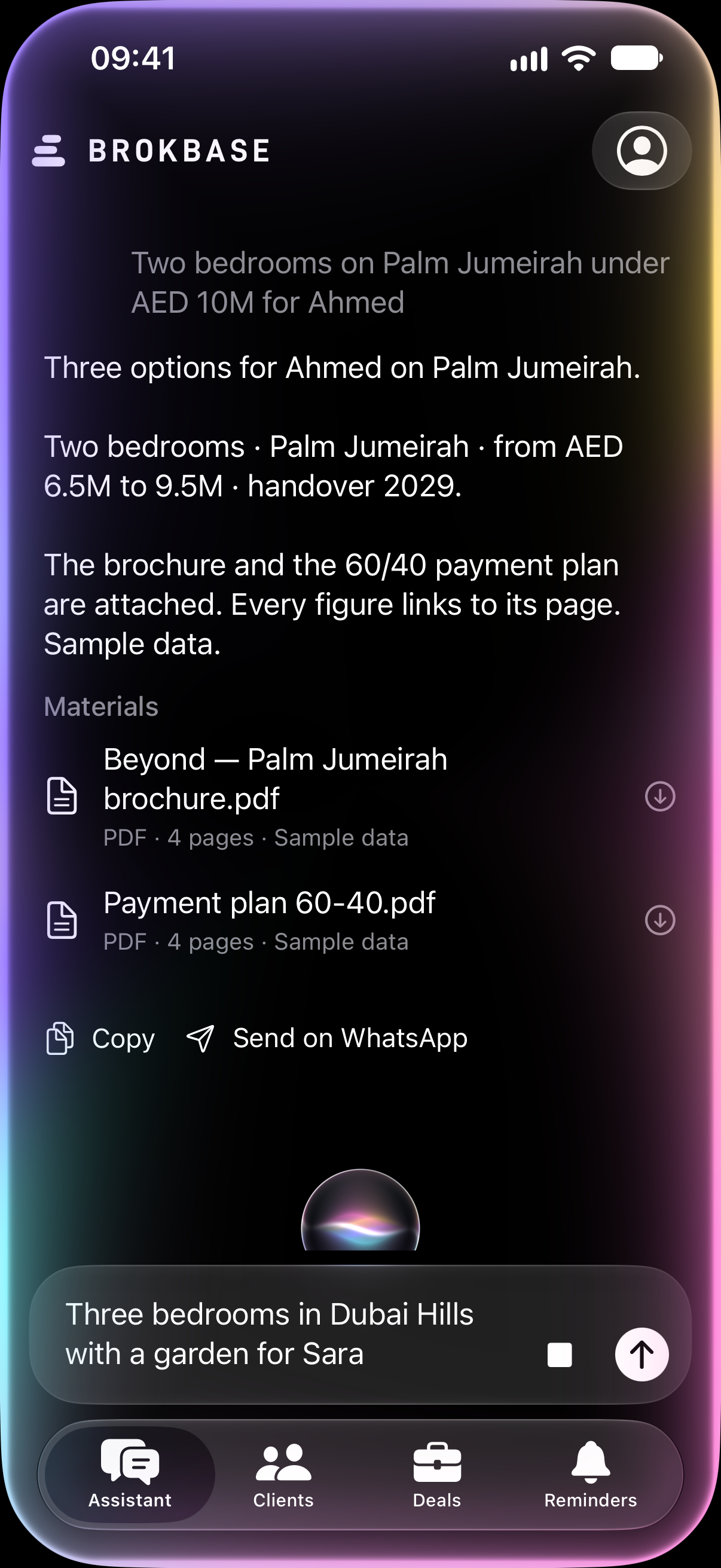 The Brokbase assistant on iPhone 17 Pro, listening: the glowing orb and the edge light while a request is dictated, above the answer about two bedrooms on Palm Jumeirah with the brochure and payment plan attached. Sample data.